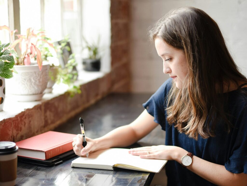 Happy woman practicing gratitude journaling
