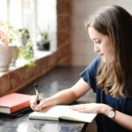 Happy woman practicing gratitude journaling